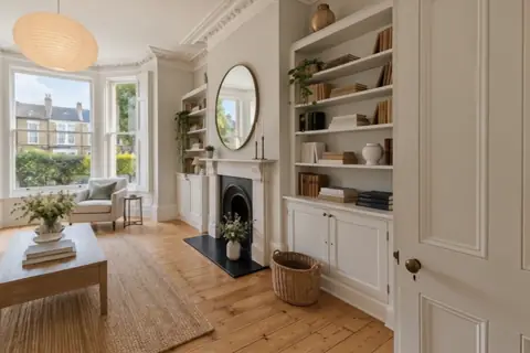 Period bay-window living room, video frame at 5s